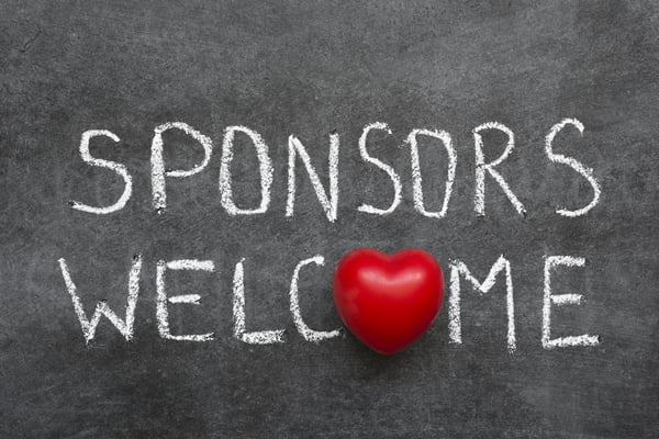 Words-“Sponsors-welcomed”-on-chalkboard-with-toy-heart