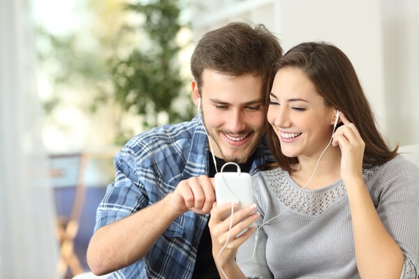 Young-good-looking-couple-watch-a-video-together-on-a-phone