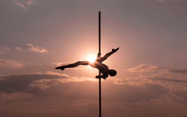 Woman-balancing-on-acrobatic-pole