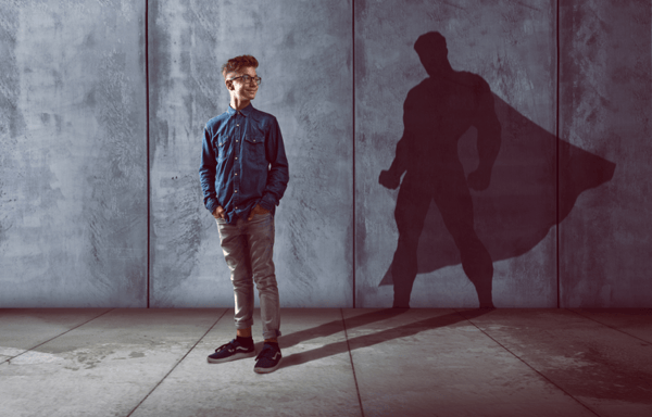 Young-nerdy-man-with-superhero-shadow