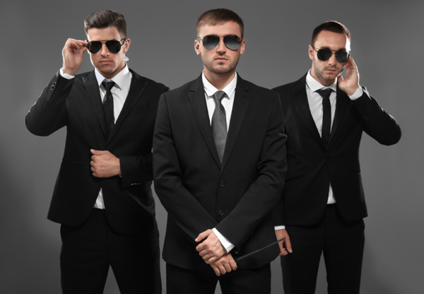 Group-of-three-bodyguards-in-suits-and-sunglasses
