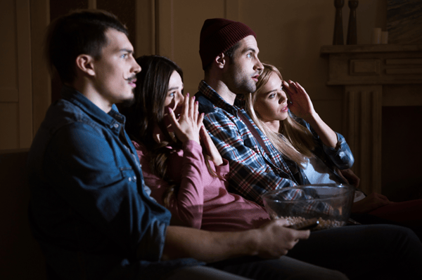 Two-young-couples-watch-scary-movie-at-home