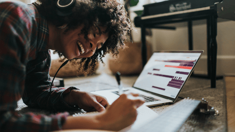A woman works on her content creation while listening to the best music for focus and concentration
