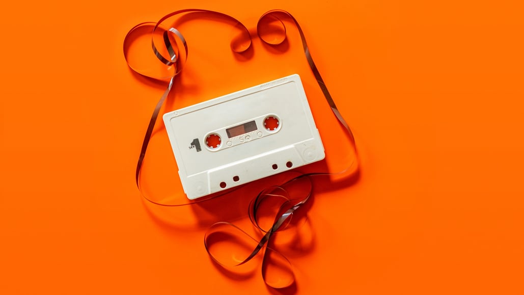 unspooled casette tape on orange background