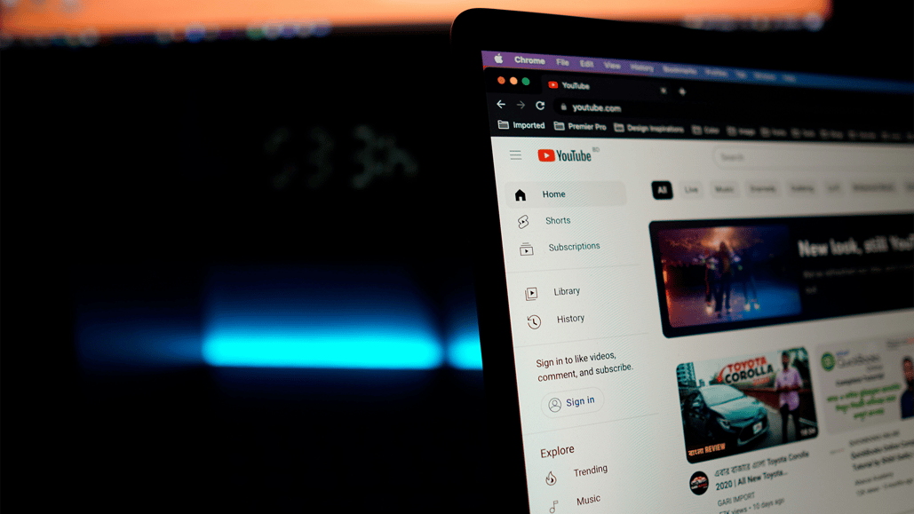 A computer screen sits open to YouTube while a content creator starts choosing music for YouTube videos
