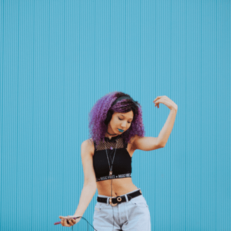 Girl dancing to music while listening with ear buds