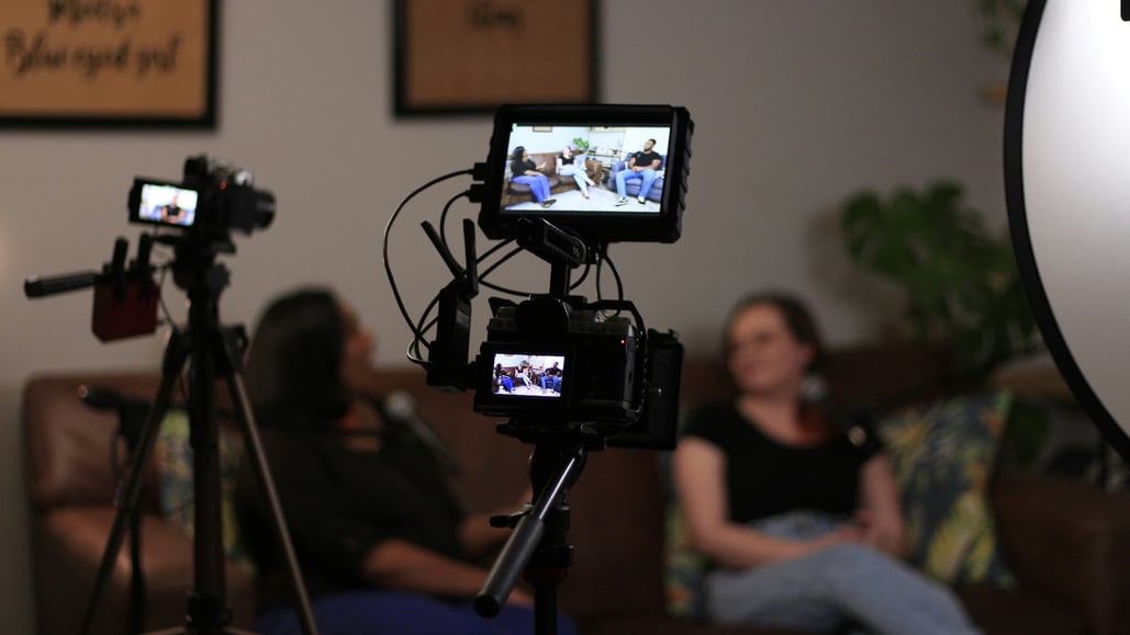 Woman being interviewed on couch